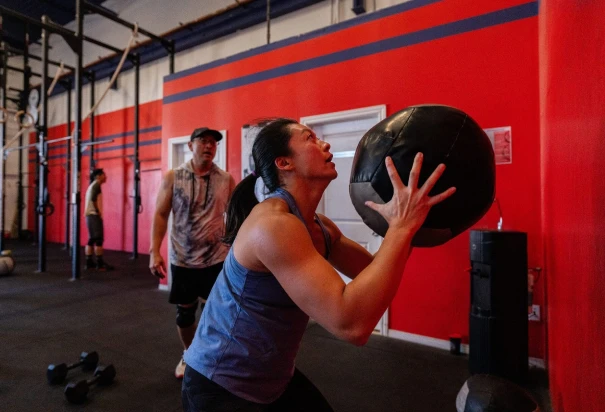 Woman doing wall ball exercise